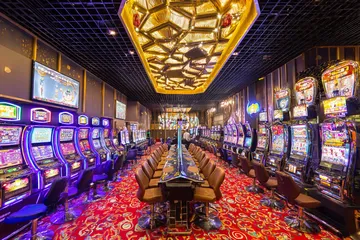 A close-up shot of golden coins falling around a spinning roulette wheel, representing immersive casino action at SPINARA.